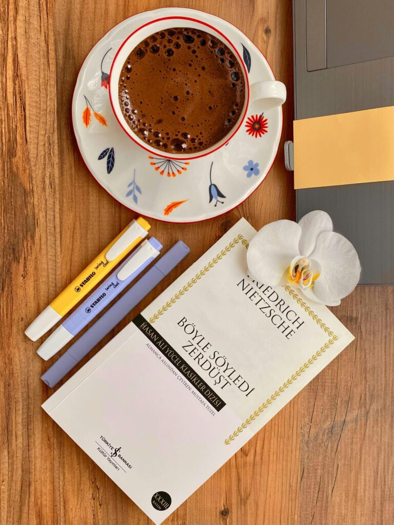 Inviting scene with Turkish coffee, a book by Nietzsche, and a serene setting in Istanbul, Türkiye.